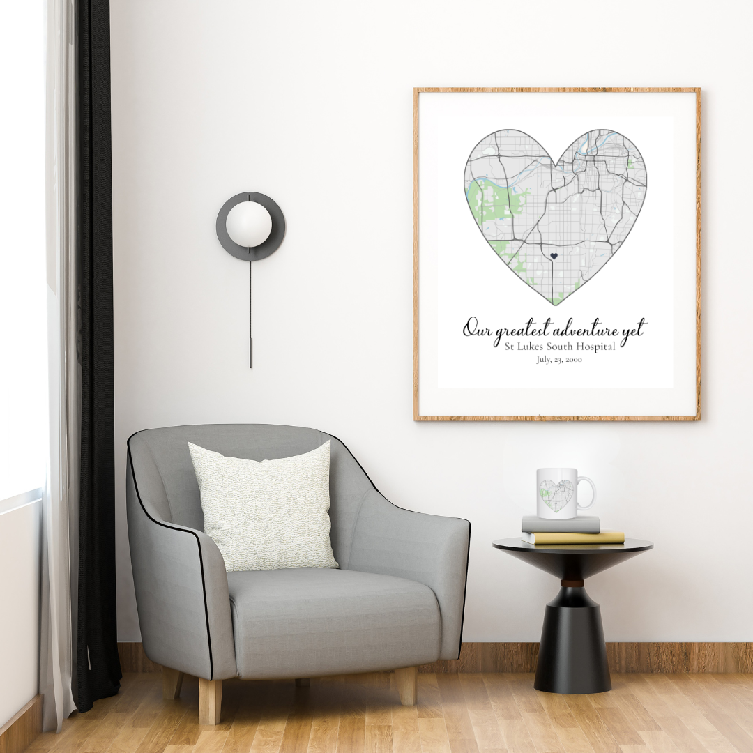 Gray armchair with a white pillow in a room with a framed heart-shaped map on the wall and matching mug.